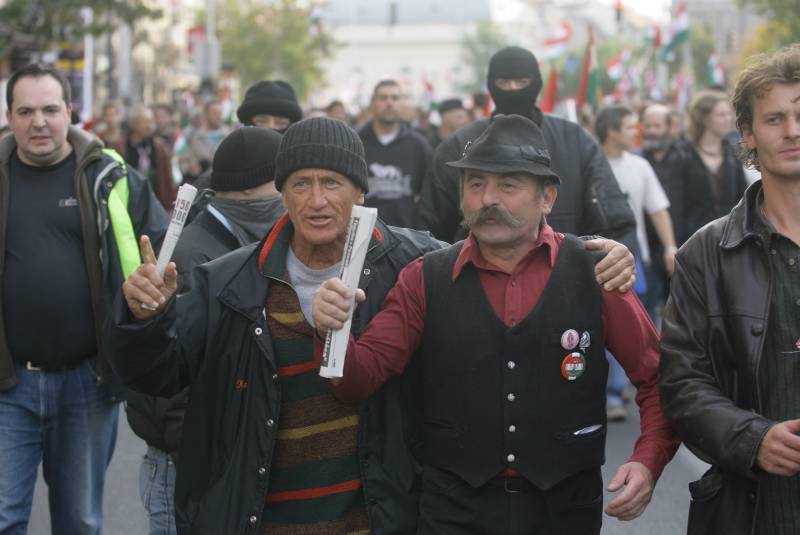 A tüntető karonfogva egy társával a menetben.